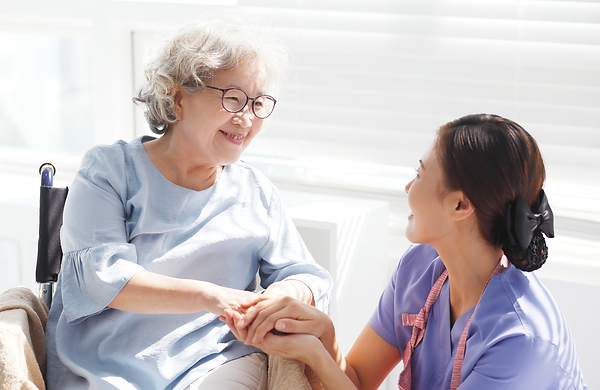 Caregiver helping elderly patient